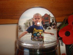 Image of a snow globe with a picture of my son inside it