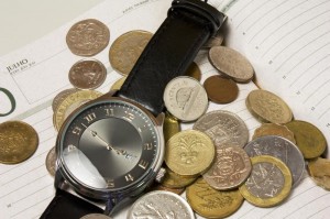 An image of a watch surrounded by money showing that time is money