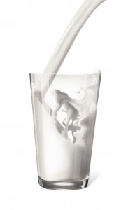An image of a glass with milk being poured into it